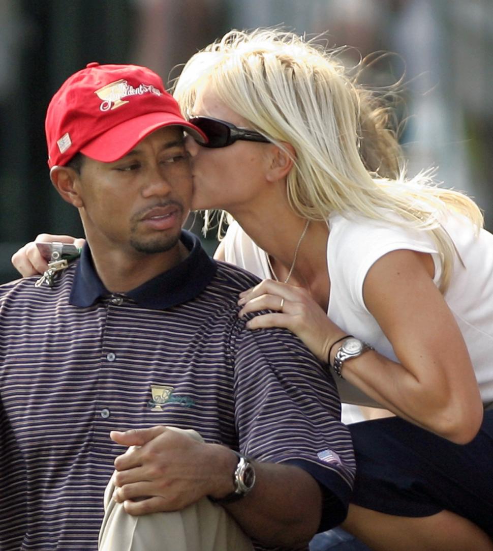 Golfer Tiger Woods getting a kiss from then-wife Elin Nordegren in 2005.