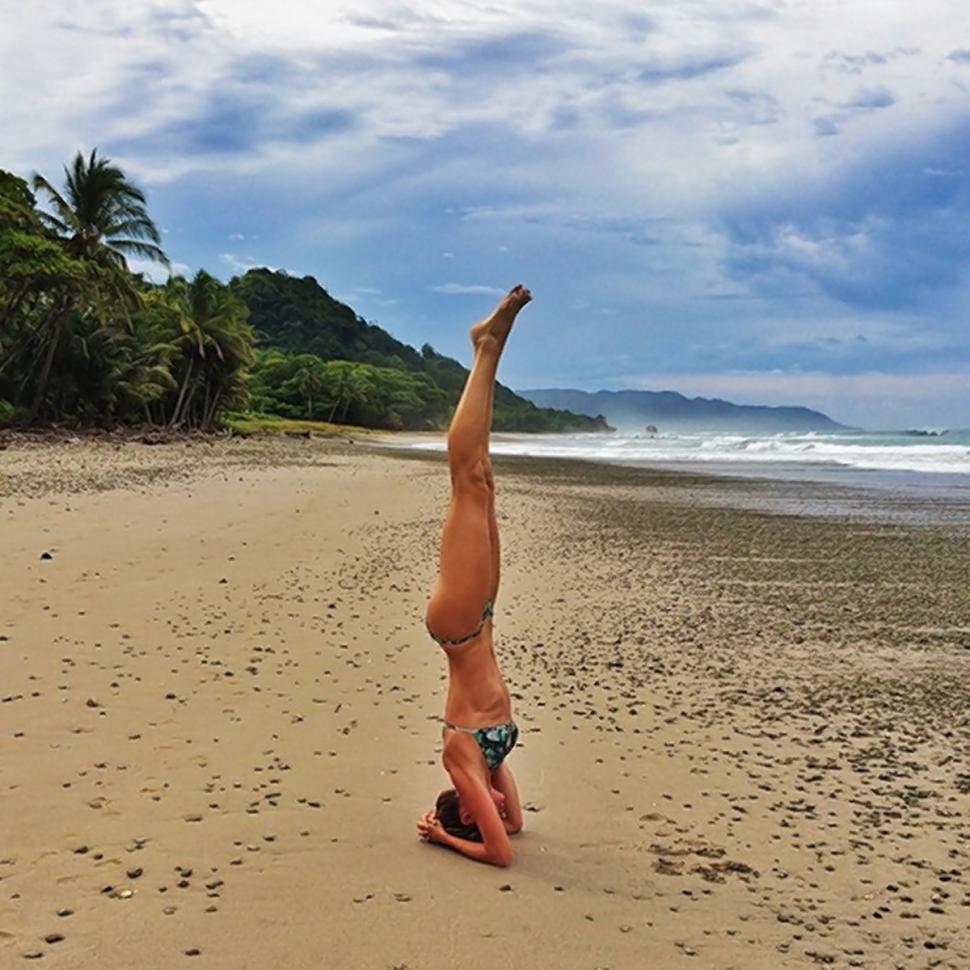 Gisele Bundchen posts a picture of herself doing yoga in a bikini on the ebach to Instagram on Aug. 9, 2014.