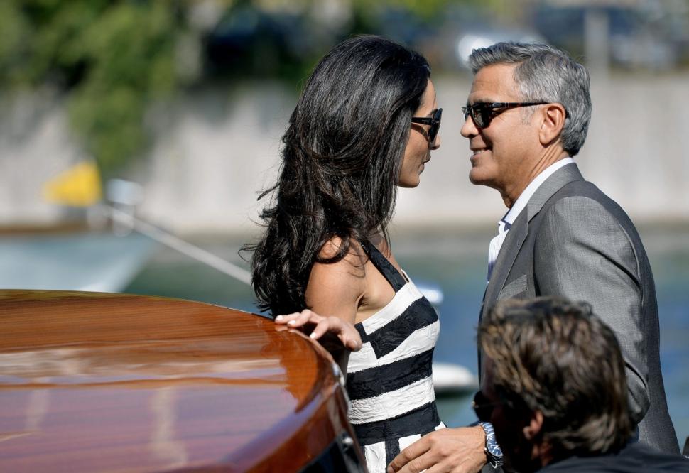 US actor George Clooney (R) and his Lebanon-born British fiancee Amal Alamuddin take a taxiboat upon their arrival in Venice on Friday.