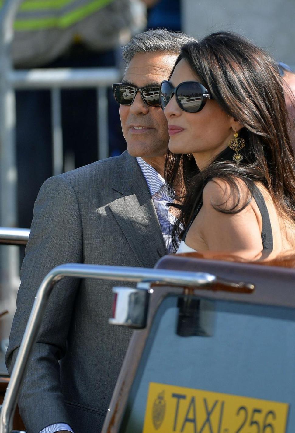 George Clooney ( L) and Amal Alamuddin, his Lebanon-born British fiancee, on a taxiboat in Venice.
