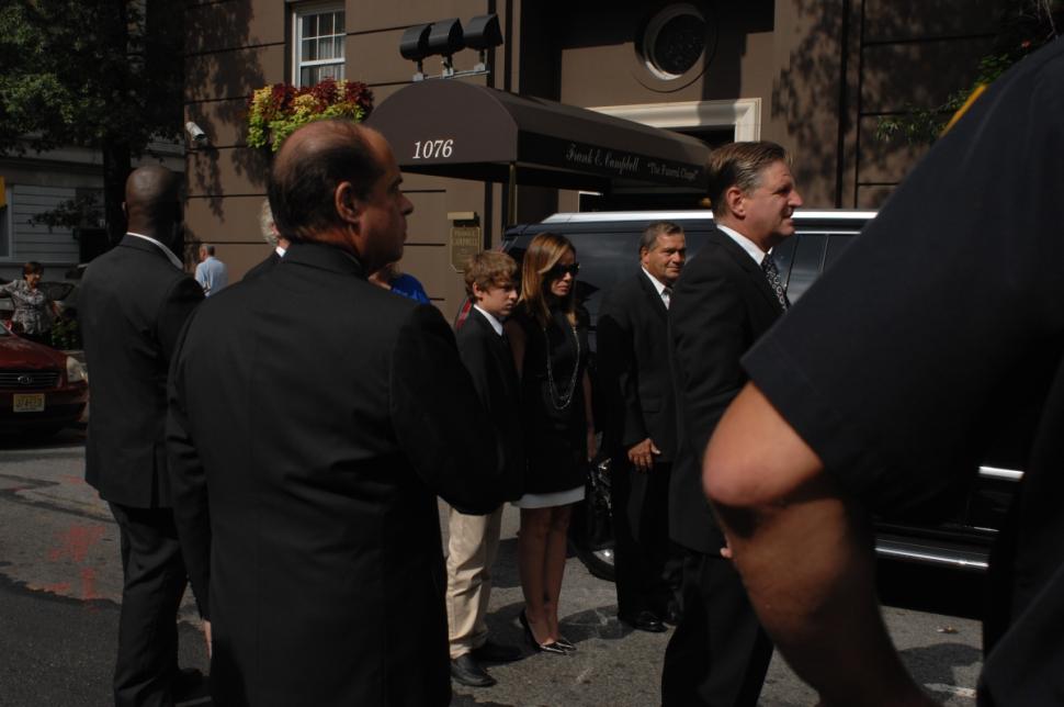 Melissa and Cooper stand with the pallbearers before the hearse sets off.