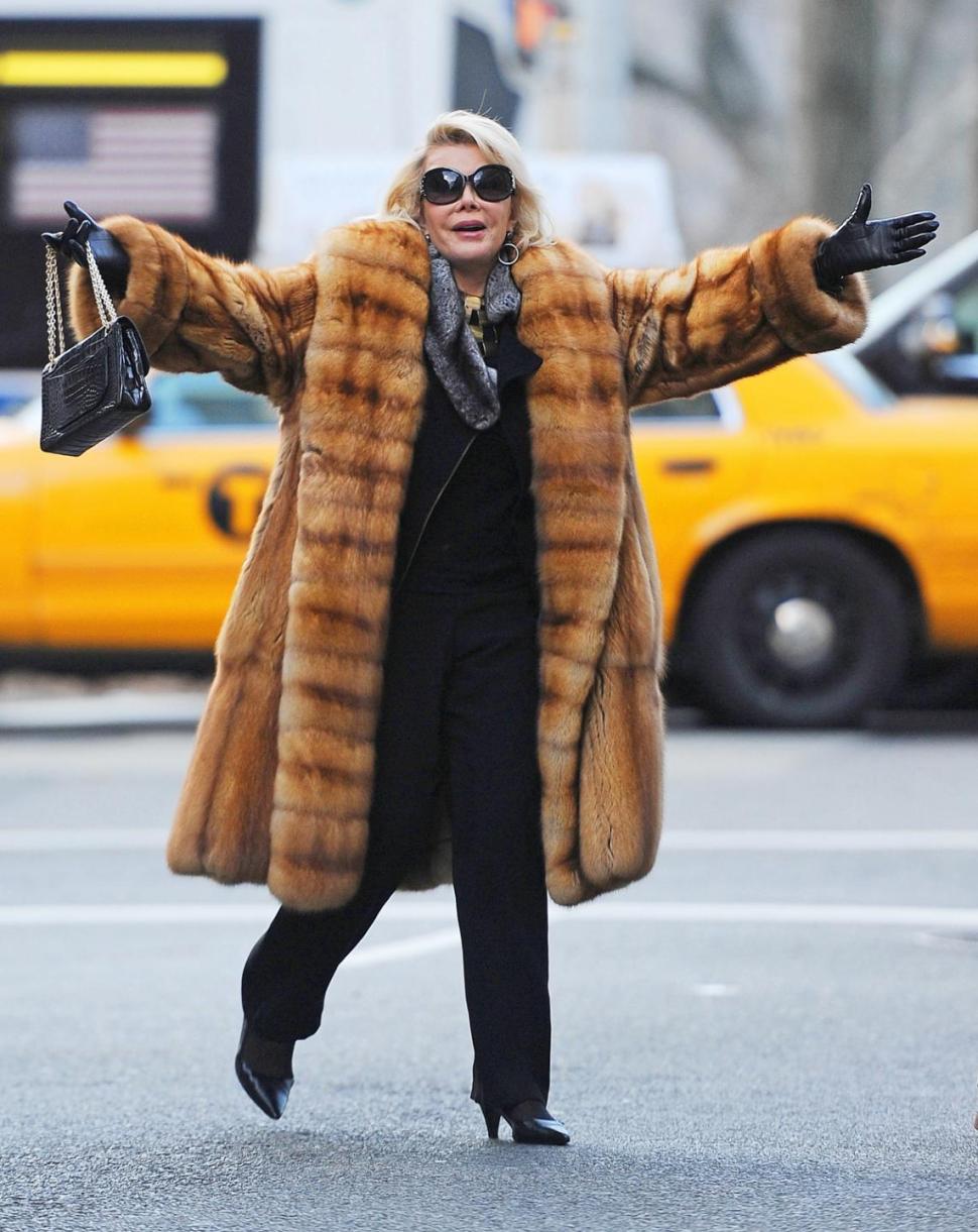 Joan Rivers welcomes photographers with open arms in New York City on Dec. 26, 2013.