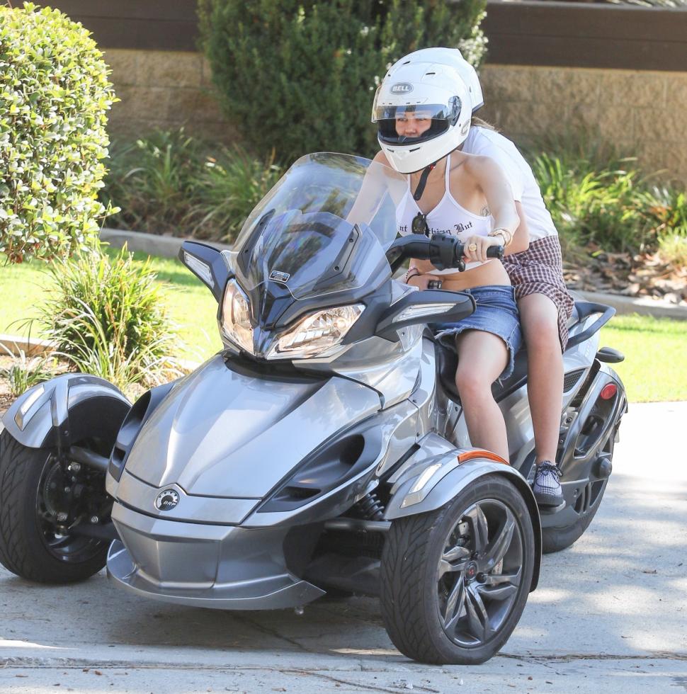 Miley and sis Noah go hard-chargin’ on her three-wheeler.