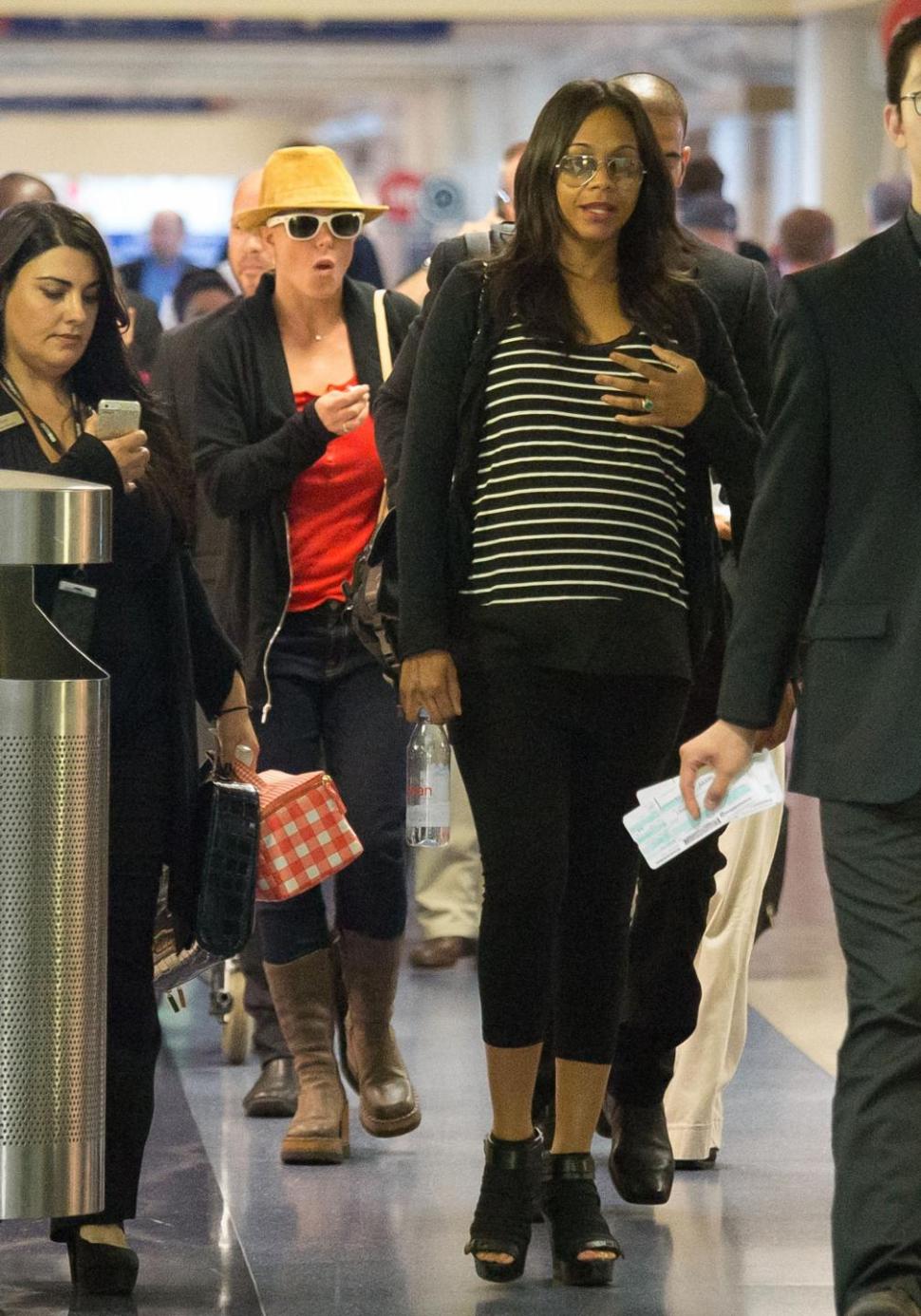 Britney Spears, left, and Zoe Saldana are seen at Los Angeles International Airport on Monday.