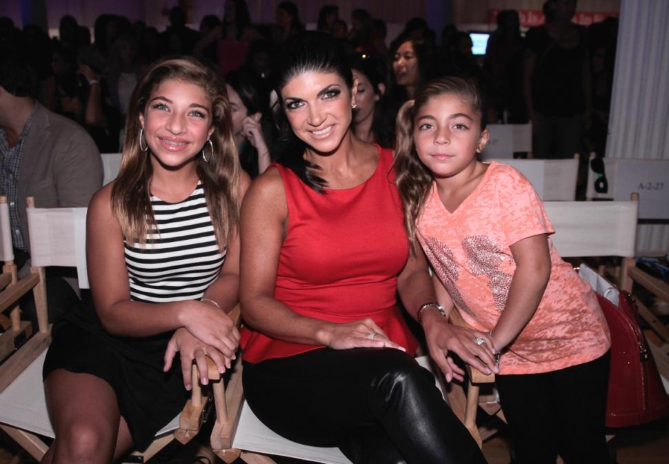 Teresa Giudice, center, and daughters Gia and Milania attend a September 2013 fashion event in New York City. The girls, along with their sisters Gabriella and Audriana, will be able to watch videos of their mom while she serves prison time starting early January.
