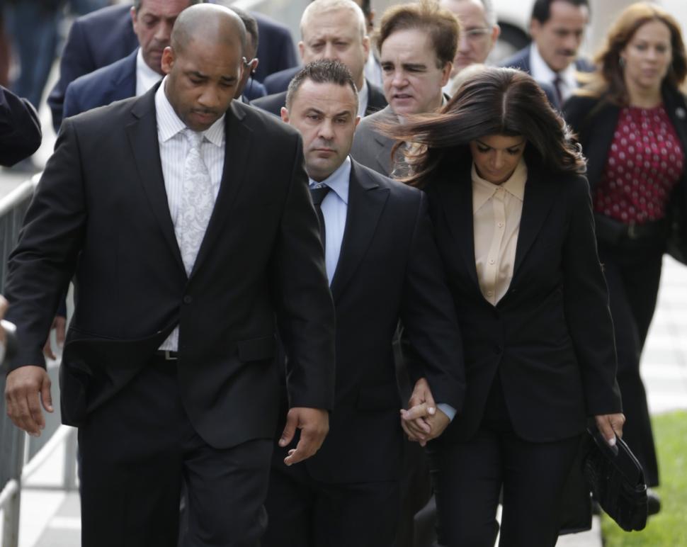‘The Real Housewives of New Jersey’ stars Giuseppe (Joe) Giudice, 43, center, and his wife, Teresa Giudice, 41, right, walk to a Newark, N.J., court in early October before their sentencings.
