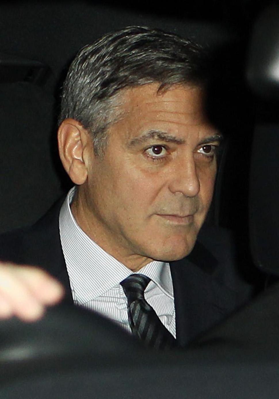 George Clooney rides in car with wife Amal Alamuddin on Saturday to British wedding bash thrown by his new in-laws.