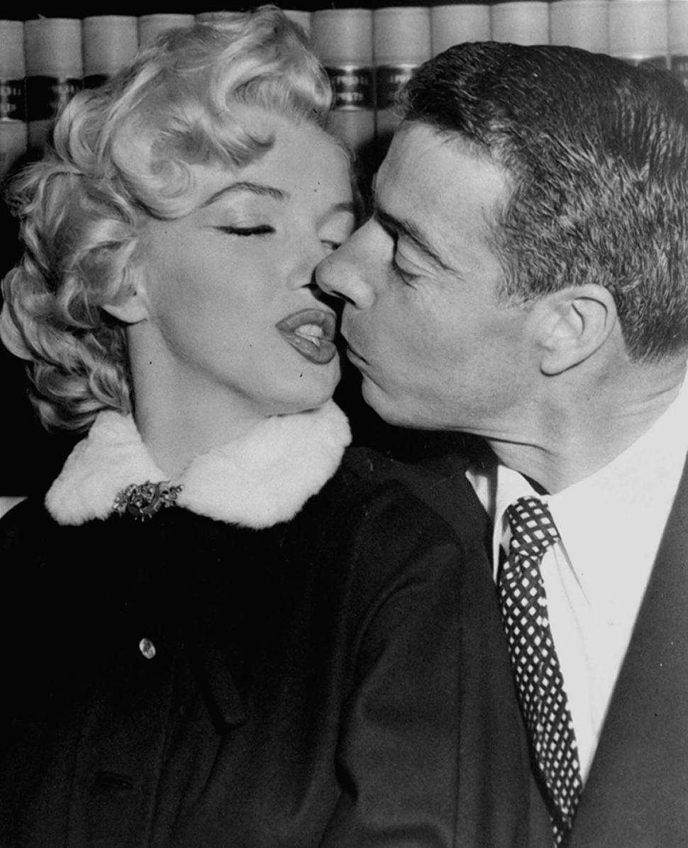 Marilyn Monroe kisses Joe DiMaggio as they wait in the judge's chambers for the marriage ceremony.
