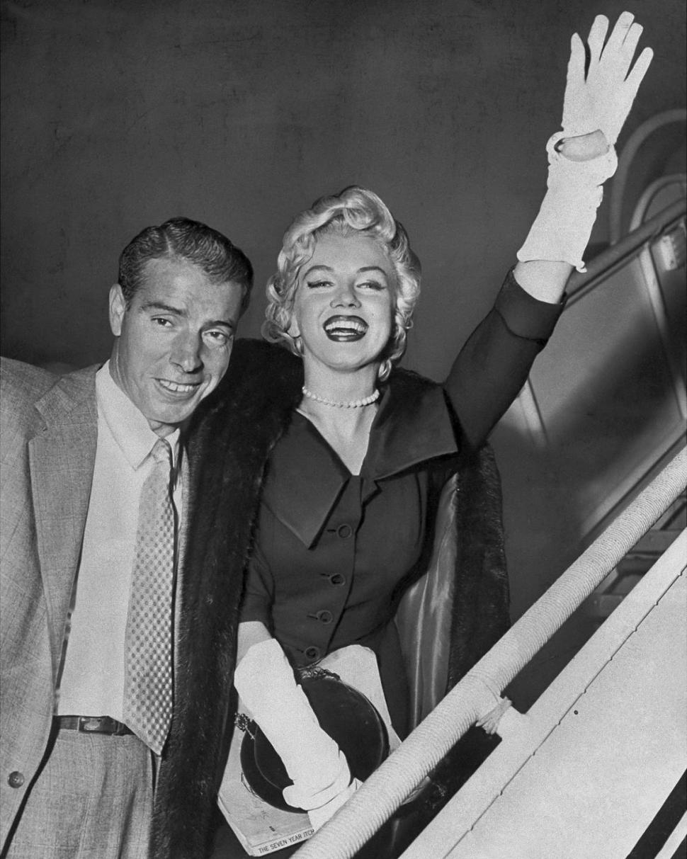 The iconic couple seen boarding a plane in 1954.