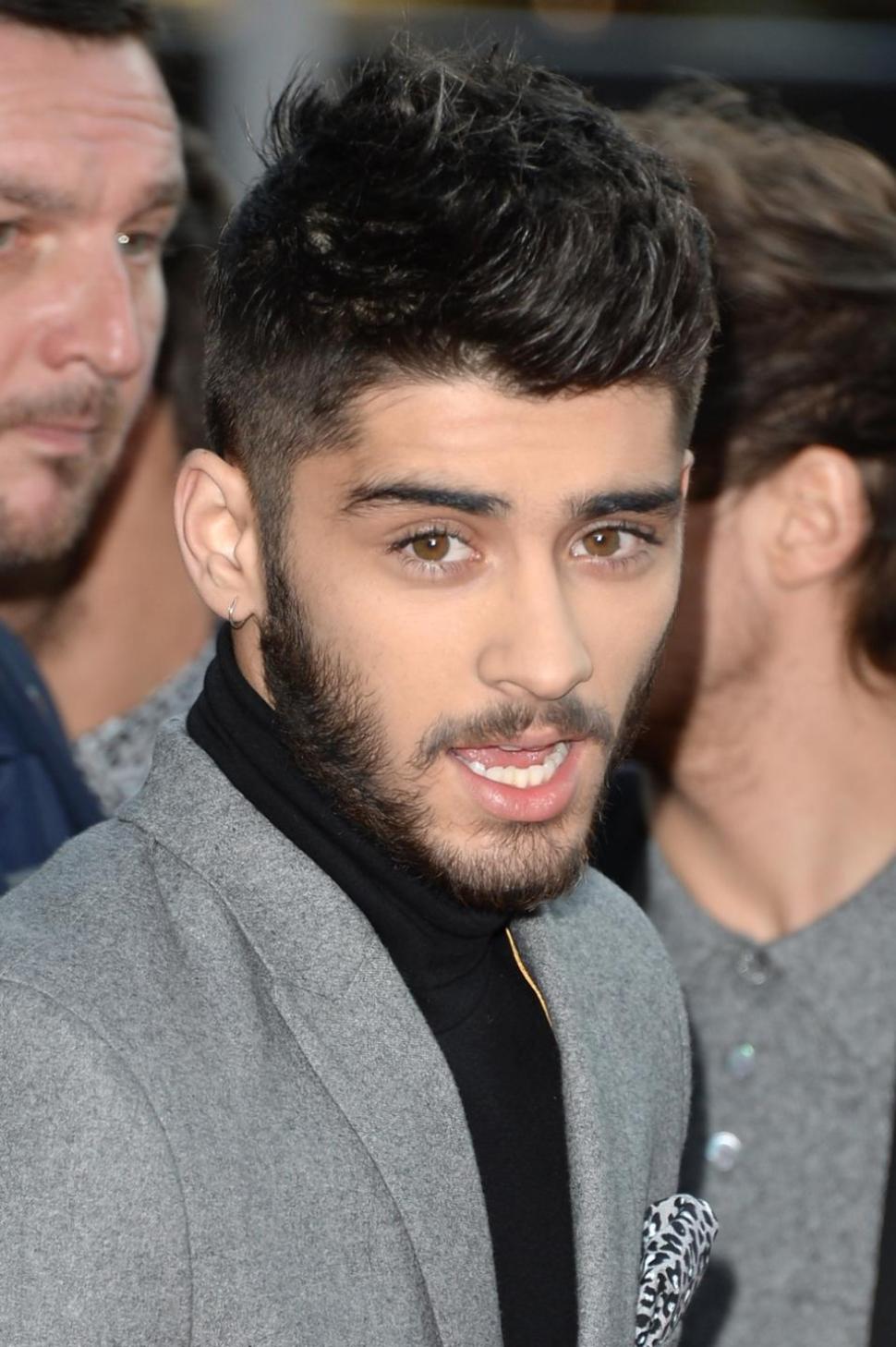 One Direction members said Zayn Malik, above, missed a show due to a stomachache.