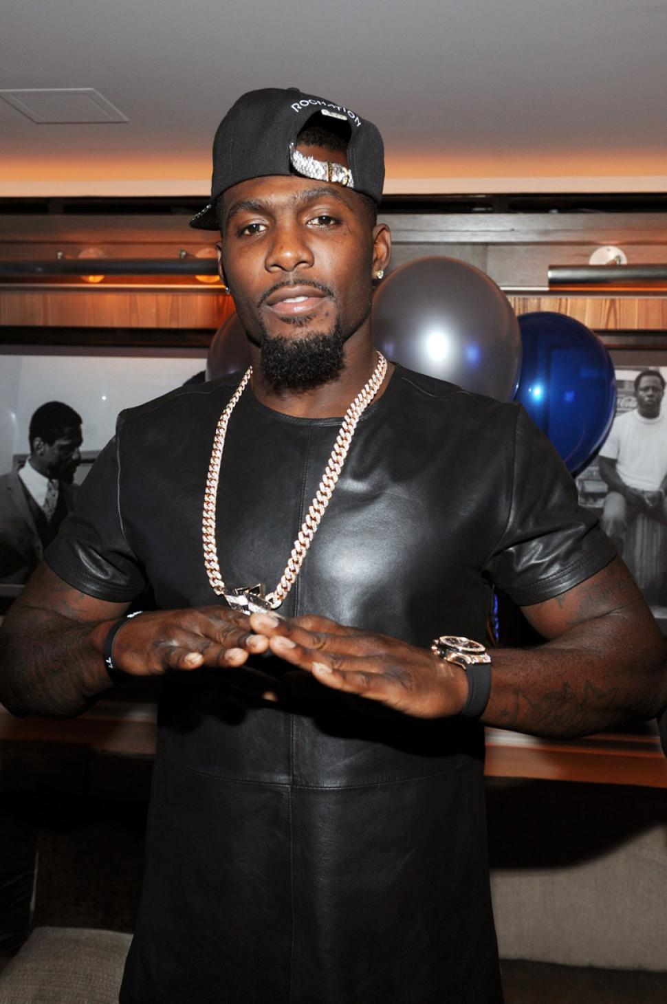 Dez Bryant throws up the Roc-A-Fella symbol at the 40/40 Club while celebrating his signing with Roc Nation.