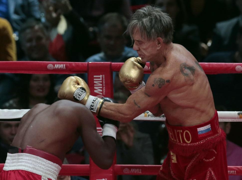 Mickey Rourke, right, trades punches with Elliot Seymour during their match at at the Rossiya concert hall in downtown Moscow.