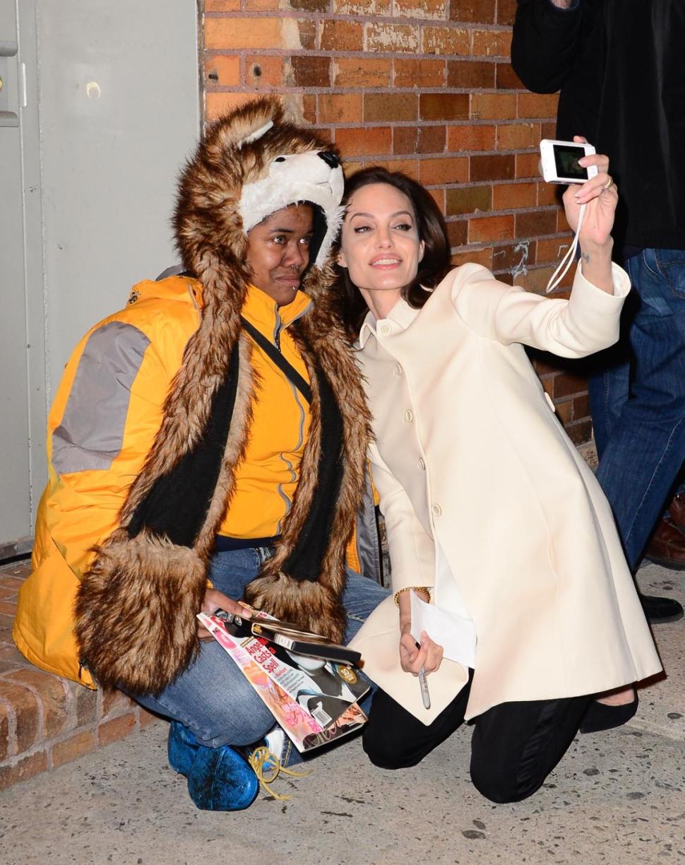 Actress Angelina Jolie is seen taking pictures with a fan outside 'The Daily Show' with a fan name named Techne on Thursday.