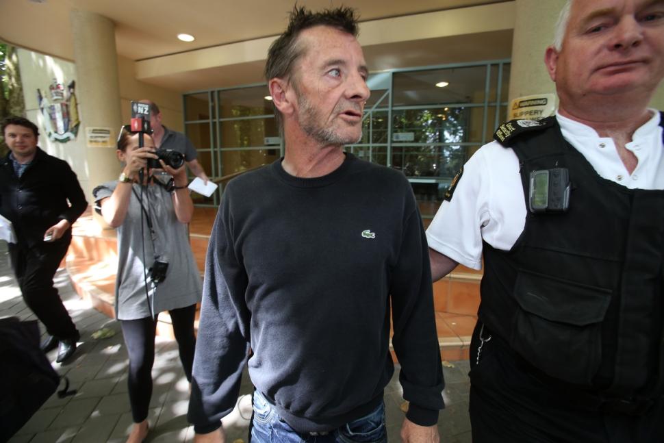 AC/DC drummer Phil Rudd leaves Tauranga District Court after being arrested in relation to breach of bail conditions on Thursday.