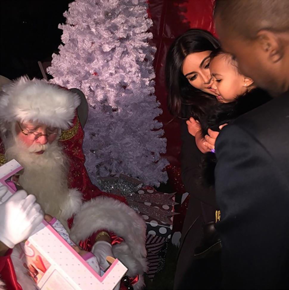 Kim Kardashian and husband Kanye West bring daughter North West to see Santa. The caption with this Instagram photo said, ‘North is still warming to Santa.’