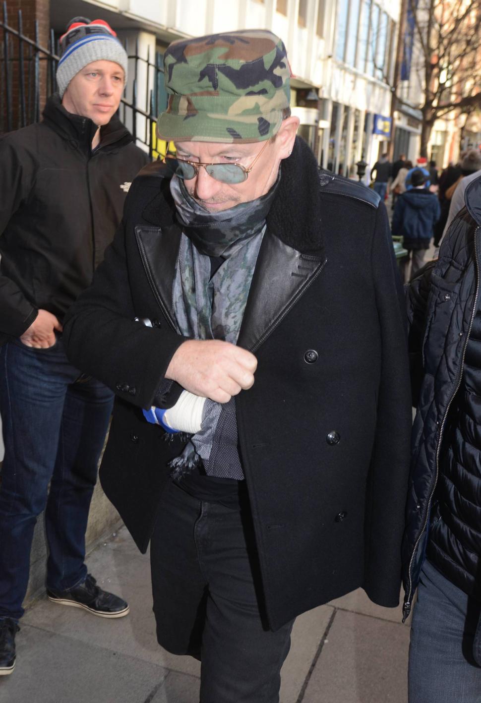 Bono, with his injured arm in a sling, in Dublin, Ireland, on Dec. 24. The singer said he's not sure if he'll ever play guitar again due to injuries suffered in a bike crash.