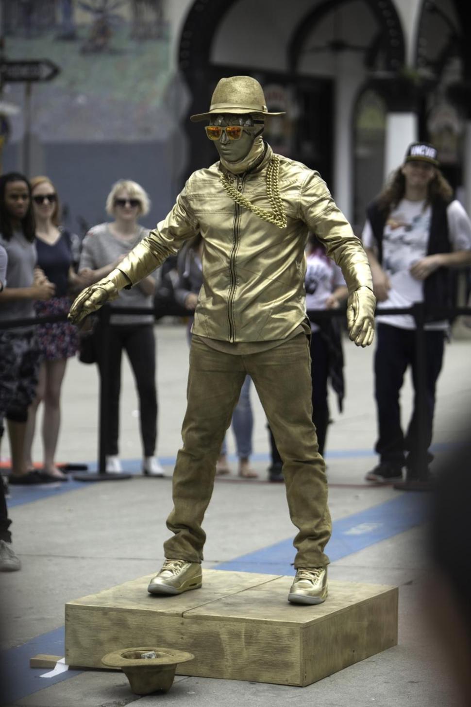 Usher suited up in gold to surprise fans with dance moves in Venice, Calif.