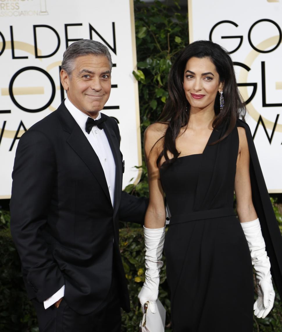 Dapper George Clooney and his stunning wife Amal are totally in glove.
