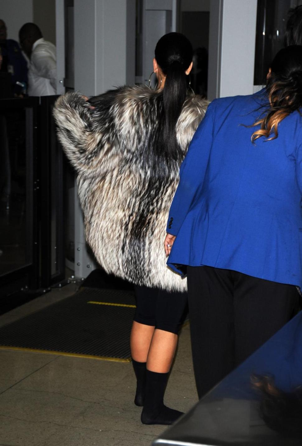 Kim Kardashian in fur coat at LAX airport in Los Angeles.