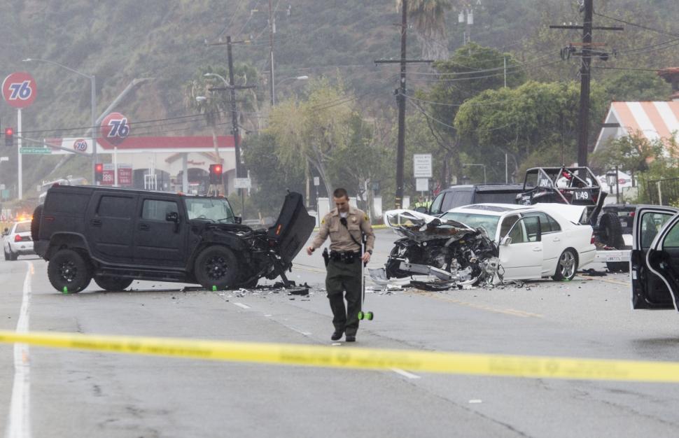 A Los Angeles County Sheriff's deputy investigates the scene of the collision.