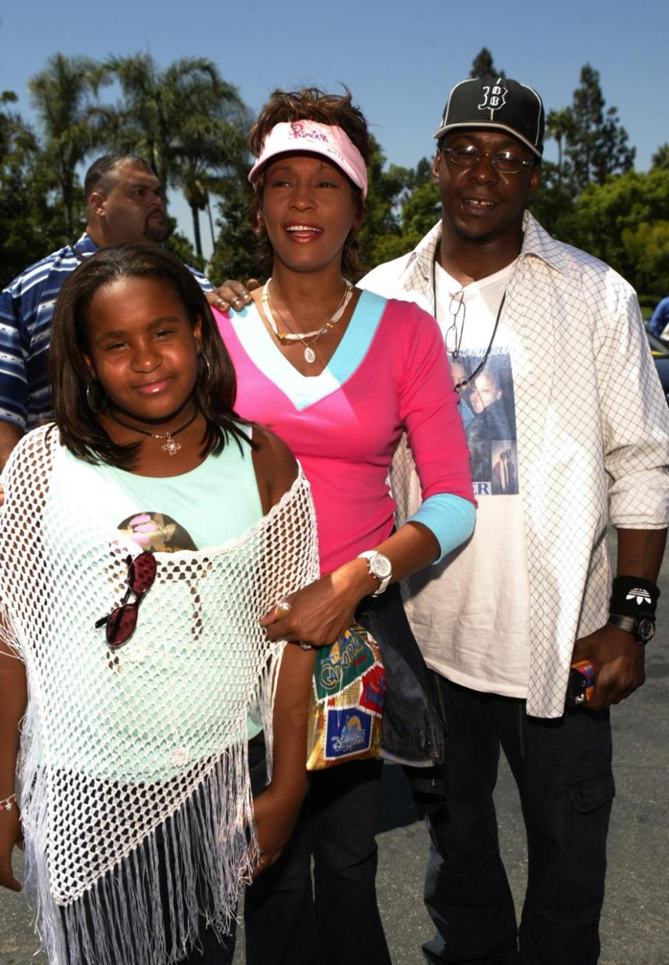 Whitney Houston (center), daughter Bobbi Kristina and Bobby Brown at the Downtown Disney Theatre in Anaheim, California.