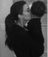 Kim Kardashian kisses North West goodnight on Instagram black and white photo.