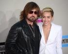 Miley Cyrus (R) and her father Billy Ray Cyrus arrive for the 2013 American Music Awards at the Nokia Theatre L.A. Live in downtown Los Angeles, California, November 24, 2013. AFP PHOTO / Frederic J. Brown (Photo credit should read FREDERIC J. BROWN/AFP/Getty Images)