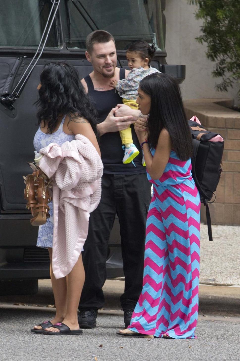 Chris Brown's alleged daughter Royalty is seen entering the star's tour bus with mother Nia Guzman-Amey and half sister in Houston on Monday.