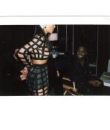 Kim Kardashian pours her curves into a see-through mesh outfit to the delight of her husband Kanye West during a Balmain photo shoot on Jan. 26, 2015.