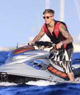 Justin Bieber rides a jet ski with Michelle Rodriguez on a boat in Ibiza, Spain.