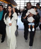 Kim Kardashian, Kanye West, and North West arrive at Los Angeles International Airport.