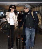 George and Amal Clooney make their way through Heathrow Airport.