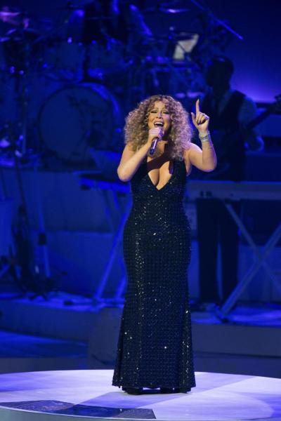 Mariah Carey, performing last week in Las Vegas, has settled a lawsuit filed by a former staffer who said she was owed overtime wages.