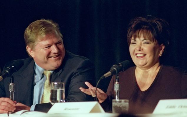 Roseanne Barr laughs as King World CEO Michael King listens during a 1998 event. King died Wednesday at 66.
