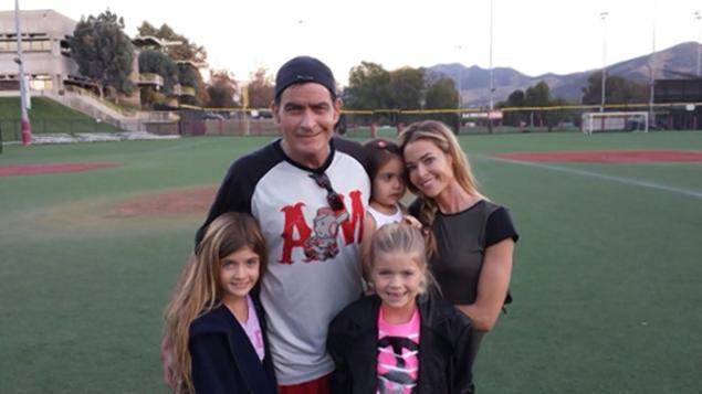 Charlie Sheen Twitter photo with Denise Richards and their daughters, Samantha and Lola, and Denise Richards' adopted daughter Eloise on a baseball field.