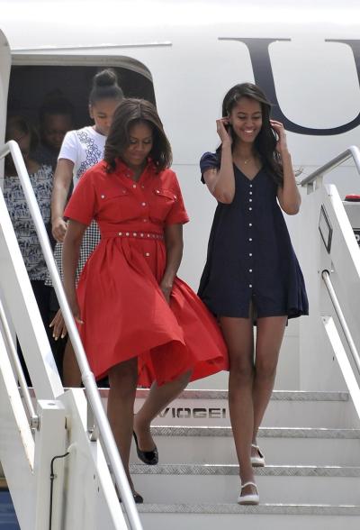 Michelle Obama, left, and daughters Malia, right, and Sasha, behind, disembark from their plane in Venice.