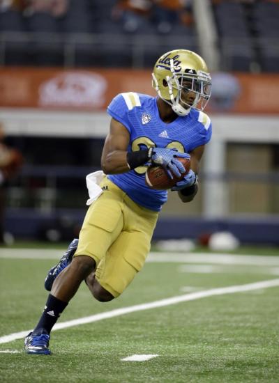 UCLA defensive back Justin Combs carries the ball after grabbing a pass during warmups before an NCAA college football game against Texas in September.