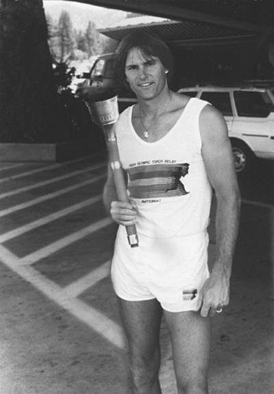 Bruce Jenner poses with the 1984 Olympic Torch he carried through Lake Tahoe, Nev. The 24-inch torch was auctioned off Thursday in Chicago.