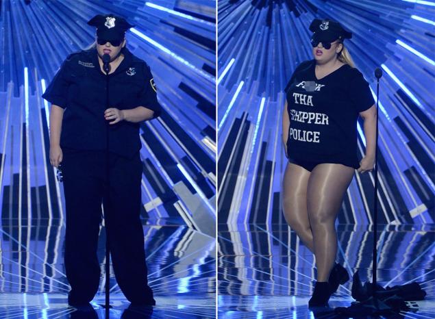 Actress Rebel Wilson presented the MTV Video Music Award for best hip-hop video while wearing a cop costume and then stripping down to a 'F--k Tha Police Strippers' shirt.