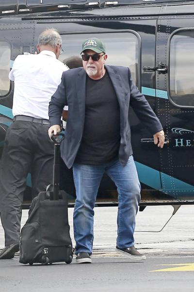 Billy Joel arrives at a Manhattan heliport Tuesday, the day before his new bride gave birth to their first child.