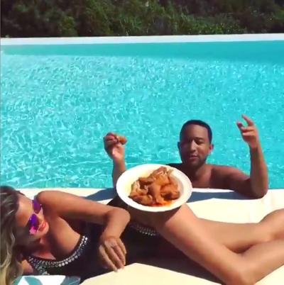 John Legend shares a video of his wife Chrissy Teigen with a plate of wings on Thursday.